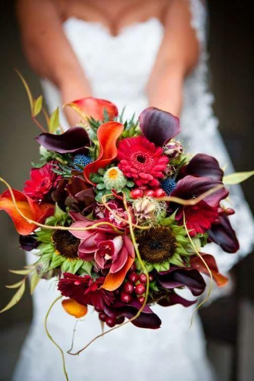 Falling In Love Bridal Bouquet - This dreamy autumn inspired bouquet includes Sunflowers, Gerbera Daisies, Calla Lillies, Hypericum Berries, Cymbidium Orchids, Branches and more hand tied in ribbon. Availability: All year round Substitute Available: Yes Design View: All Facing View Photo shown: Regular  Must be ordered 3-5 days in advance to delivery date.