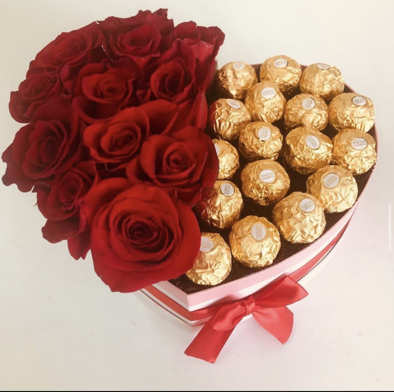 Chocodelicious  - Convine the best of chocolates and red roses to show your favorite person how much they mean to you!. 12 red roses in a pink heart shape box with 16 Ferrero Rocher. 