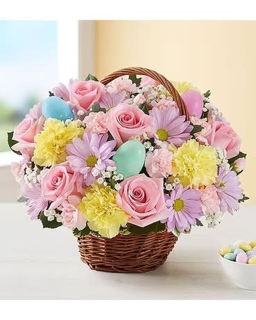 Easter Egg Basket - We’ve gathered the freshest blooms in pastel shades of pink, yellow, and lavender inside a rustic basket with colorful Easter eggs for a truly lovely surprise.
