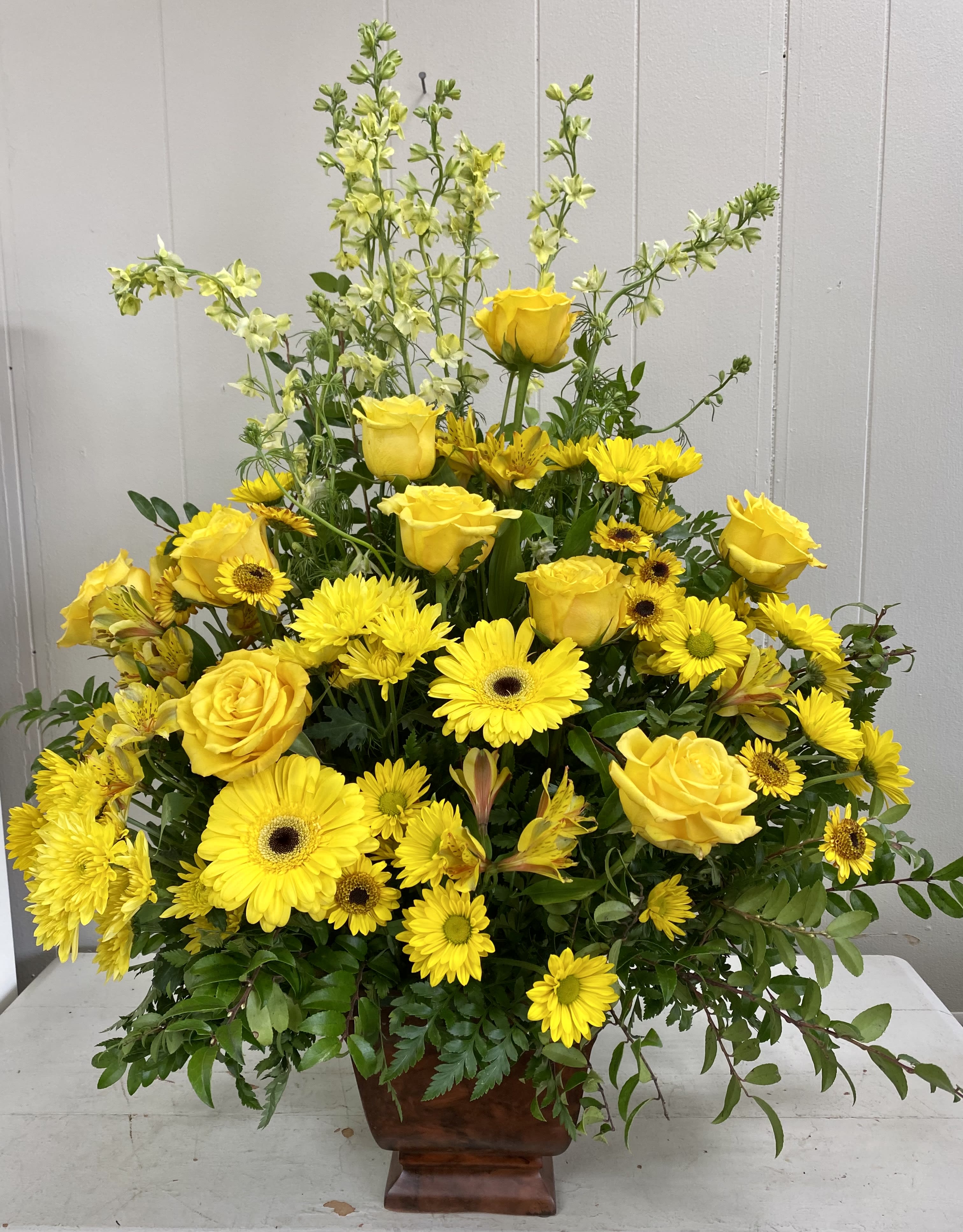 Sunny Memories Sunny Memories - Honor a bright spirit who was like a ray of sunshine to everyone they encountered, with a grand display of bold yellow blossoms. At more than three feet tall, it will add a touch of brightness to any tribute.