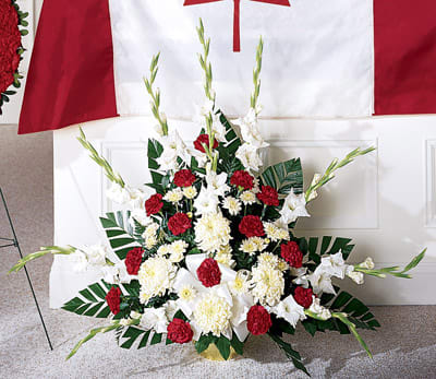 Cherished Farewell Arrangement - This patriotic arrangement is a beautiful tribute to anyone who's served. A bold combination of red &amp; white is accented with assorted greenery and a complementary bow.