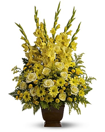 Sunny Memories - Honor a bright spirit who was like a ray of sunshine to everyone they encountered, with a grand display of bold yellow blossoms. At more than three feet tall, it will add a touch of brightness to any tribute. A mix of fresh yellow flowers such as roses, gladioli and chrysanthemums - accented with fern - is delivered in a Noble Heritage urn.  SUBSTITUTION POLICY – Always deliver the freshest flowers! Please note the bouquet pictured reflects our original design.  If the exact flowers or container in this arrangement are not available, our local florists will create a beautiful bouquet with the freshest available flowers.