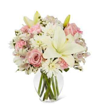 The FTD Pink Dream Bouquet - THIS IS FOR THE STANDARD, DELUXE OR PREMIUM.  Classically elegant in a way that will never go out of style this fresh flower arrangement is truly a dream. Pink roses and pink mini carnations are soft and sophisticated amongst a bed of white Asiatic Lilies Peruvian Lilies chrysanthemums and statice perfectly accented with lush greens while situated in a classic clear glass vase. A gorgeous birthday thank you or Mother's Day gift! GOOD bouquet includes 8 stems. Approx. 13&quot;H x 12&quot;W. BETTER bouquet includes 11 stems. Approx. 14&quot;H x 13&quot;W. BEST bouquet includes 13 stems. Approx. 17&quot;H x 15&quot;W.