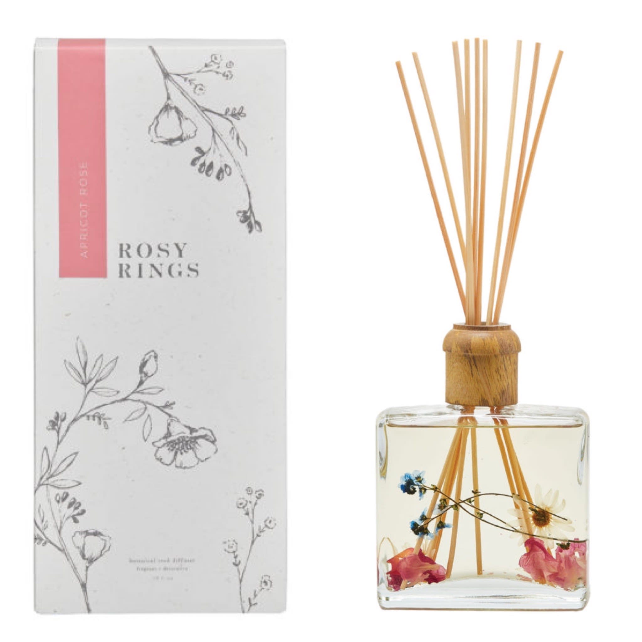 Rosy Rings Apricot Rose Botanical Reed Diffuser Rosy Rings Apricot Rose Botanical Reed Diffuser - A big, dewy bouquet of pastel roses and almond blossom sweetened by juicy apricot and mirabelle plum. 13 oz./Lasts 6-12 months avg. Gorgeous packaging is the perfect complement to dramatic square bottles filled with real spices, fruit and botanicals. Every natural element you see inside the glass vessel is delicately placed there by hand. Lovingly packaged with a wooden cap + 10 reed sticks.
