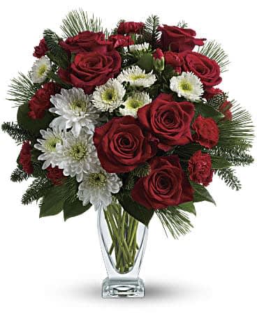 Teleflora's Winter Kisses Bouquet Teleflora's Winter Kisses Bouquet - No mistletoe required! Simply send this romantic bouquet of snow whites and rich reds arranged in our sculpted glass vase, and you're guaranteed a spot on her "nice" list.