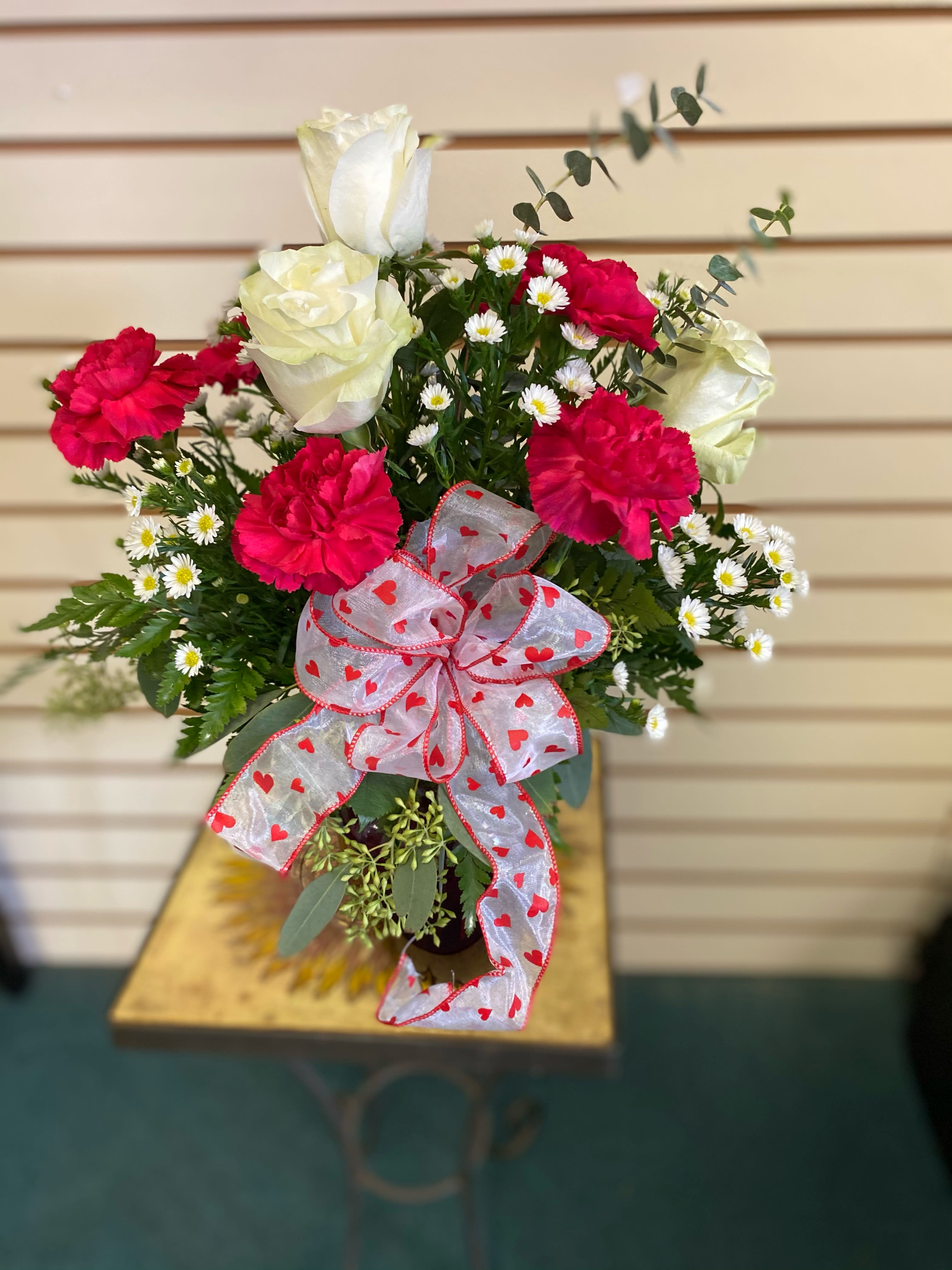 Dance with Me Bouquet - Turn up the heat on your relationship with this sizzling bouquet of carnations and roses in a sparkling glass red vase. It makes a spectacular gift for anniversary or any loving occasion. 