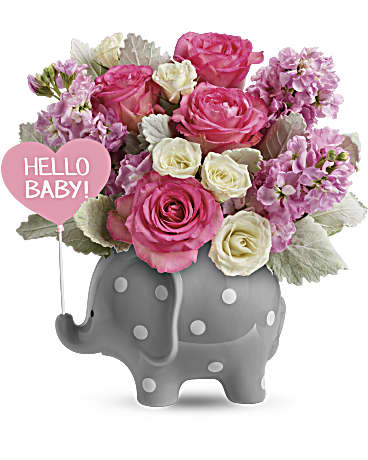 Teleflora's Hello Sweet Baby - Pink - Celebrate a sweet girl's arrival with this precious ceramic elephant, bursting with pink blooms and darling polka dots! This adorable gift features pink roses, white spray roses, pink stock, and dusty miller. Delivered in Teleflora's Hello Baby Elephant. Orientation: One-Sided