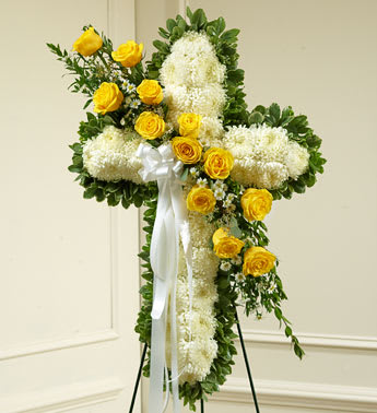 Peace and Prayers Standing Cross - Yellow - Product ID: 91199   Send a beautiful floral tribute that expresses all the love and sympathy you feel during this difficult time. This standing spray arrangement â in the shape of a cross â is created from fresh yellow and white flowers such as roses, football mums and more. Traditionally sent directly to the funeral home by family members or friends and displayed on a stand. Due to the urgency of the occasion, our florists use only the freshest flowers available, so varieties and colors may vary. Measures approximately 42&quot;H x 28&quot;L without easel.