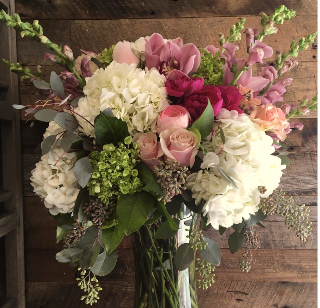 Better Together - Grandiose and elegant! Our arrangement is perfect when you need to send something extra special. A sweet, romantic mix of soft blush pink roses and garden spray roses nestled in a bed of white hydrangea. 