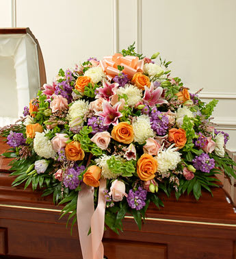 Cherished Memories Pastel Half Casket Cover - Product ID: 91402   Their life was filled with beauty and joy. Remember all the love and happiness they shared with this casket cover arrangement in soothing and delicate pastel shades. Our expert florists use their artistic skills to create a touching final tribute for an immediate family member who meant more than words can ever convey. Half casket cover arrangement of fresh pastel blooms such as long-stem roses, lilies, mums, Bells of Ireland, stock, lisianthus, heather and more Traditionally sent by the immediate family to the funeral home Our florists use only the freshest flowers available, so colors and varieties may vary Measures approximately 18âH x 38&quot;L x 28&quot;D
