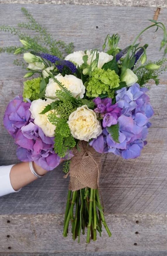 Designer choice - A mix of beautiful seasonal flowers,picked by our designer and arranged in a decorated hand tied bouquet 