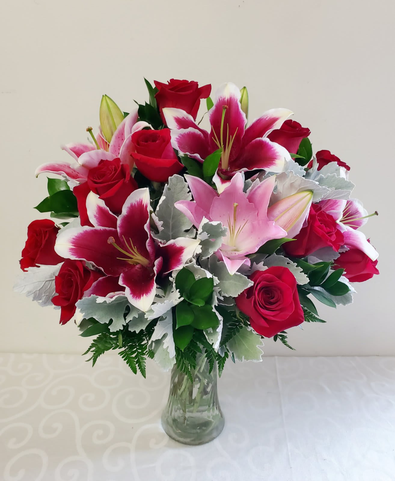My Gorgeous Star Bouquet | Approximately 22H by 18W - 1 Dozen Premium Red Roses  Designed with beautiful Stargazer Lilies Accented with Dusty Miller and Ruscus Leaves.