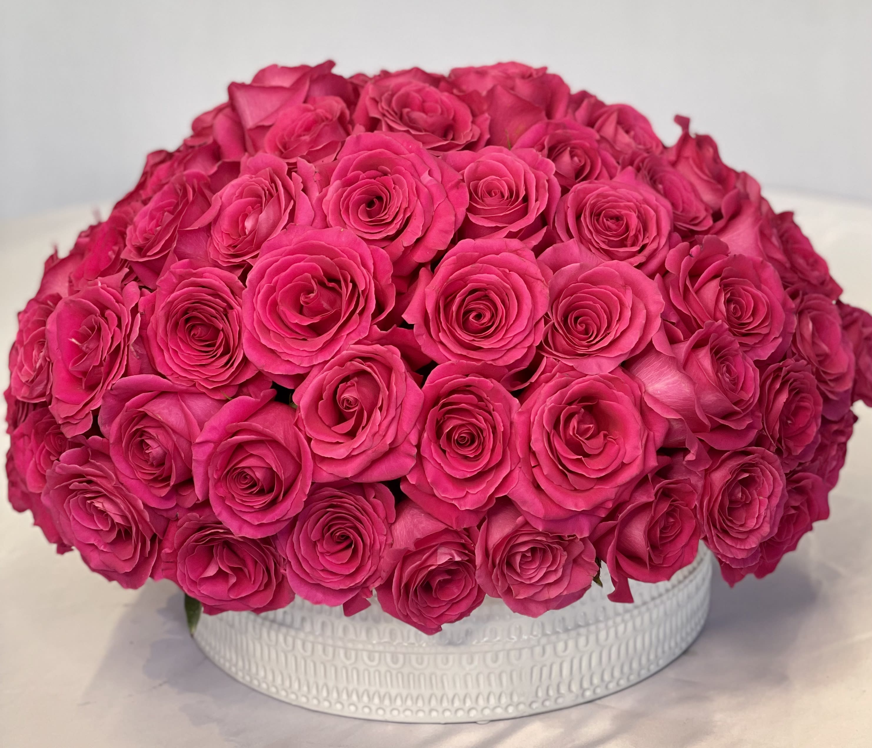 Flaming Pink - Beautiful arrangement featuring, Hot Pink Roses Arrange in a large container.
