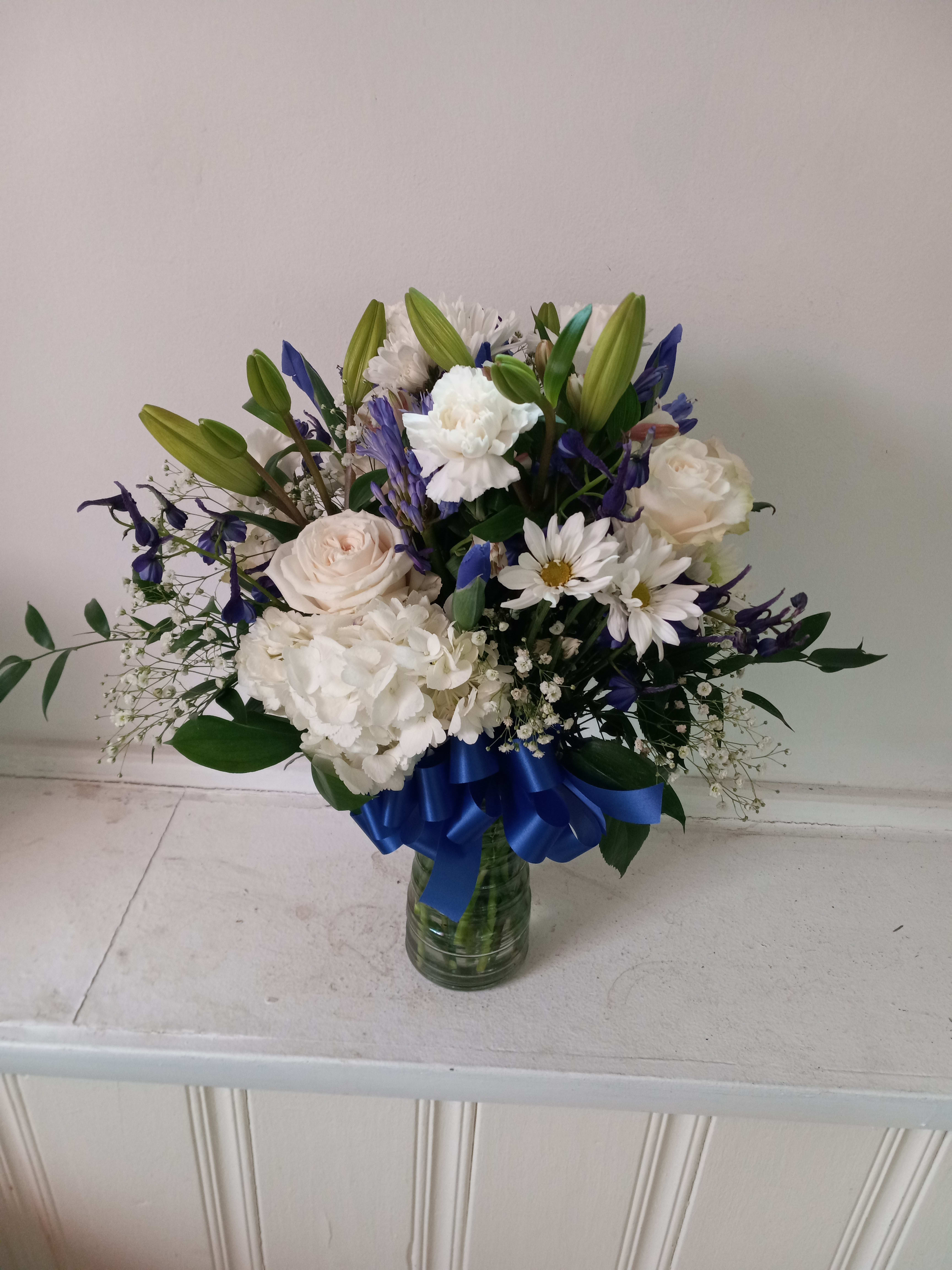 Nautica  - Beautiful mix of white roses, daisies, carnations, hydrangea &amp; navy/blue irises, statice and delphinium in a vase