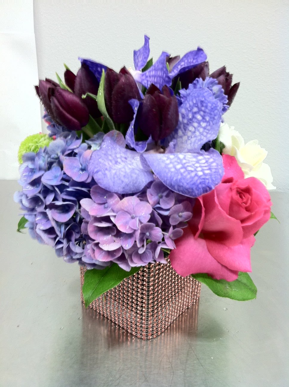 Sophisticated Spring Arrangement - This mixed arrangement features purple tulips, hydrangea, roses, and vanda orchids. *as shown $150.00