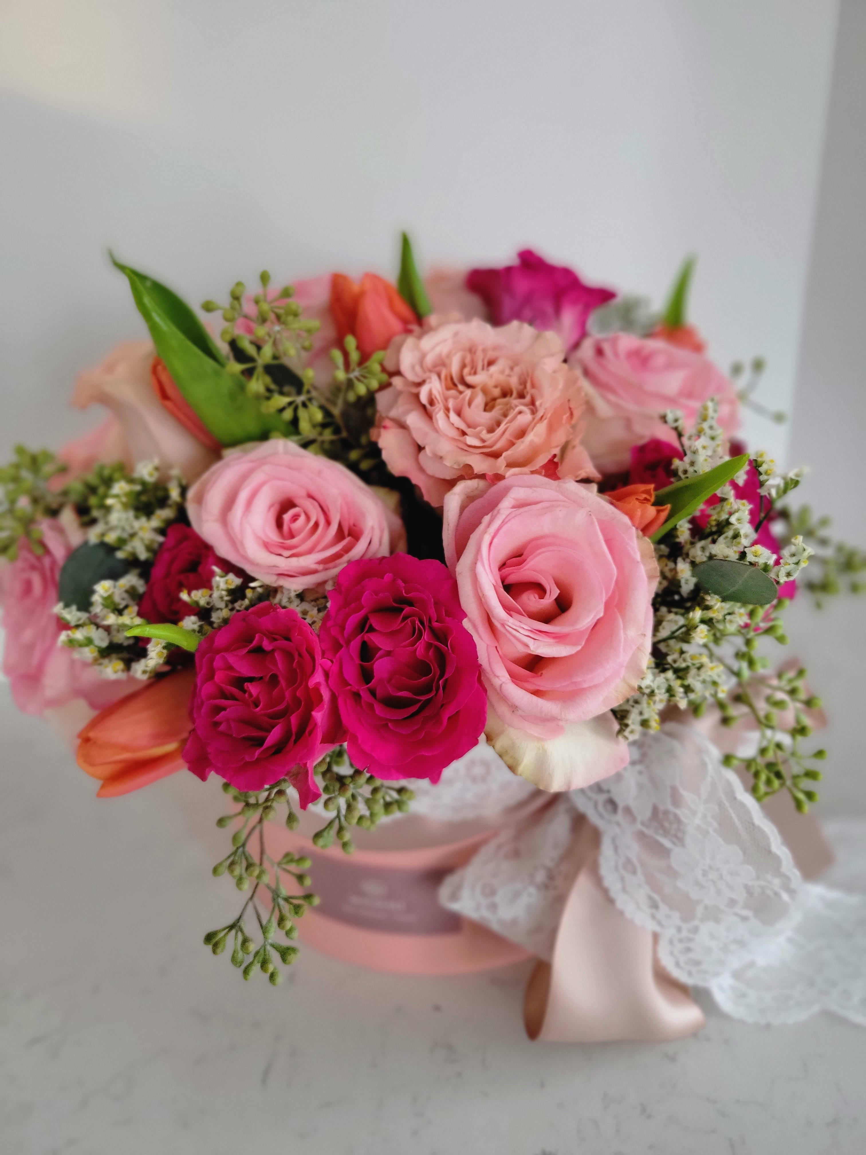 Baby Love - A variety of  pink roses, light orange tulips, and some fillers in a decorated flower box