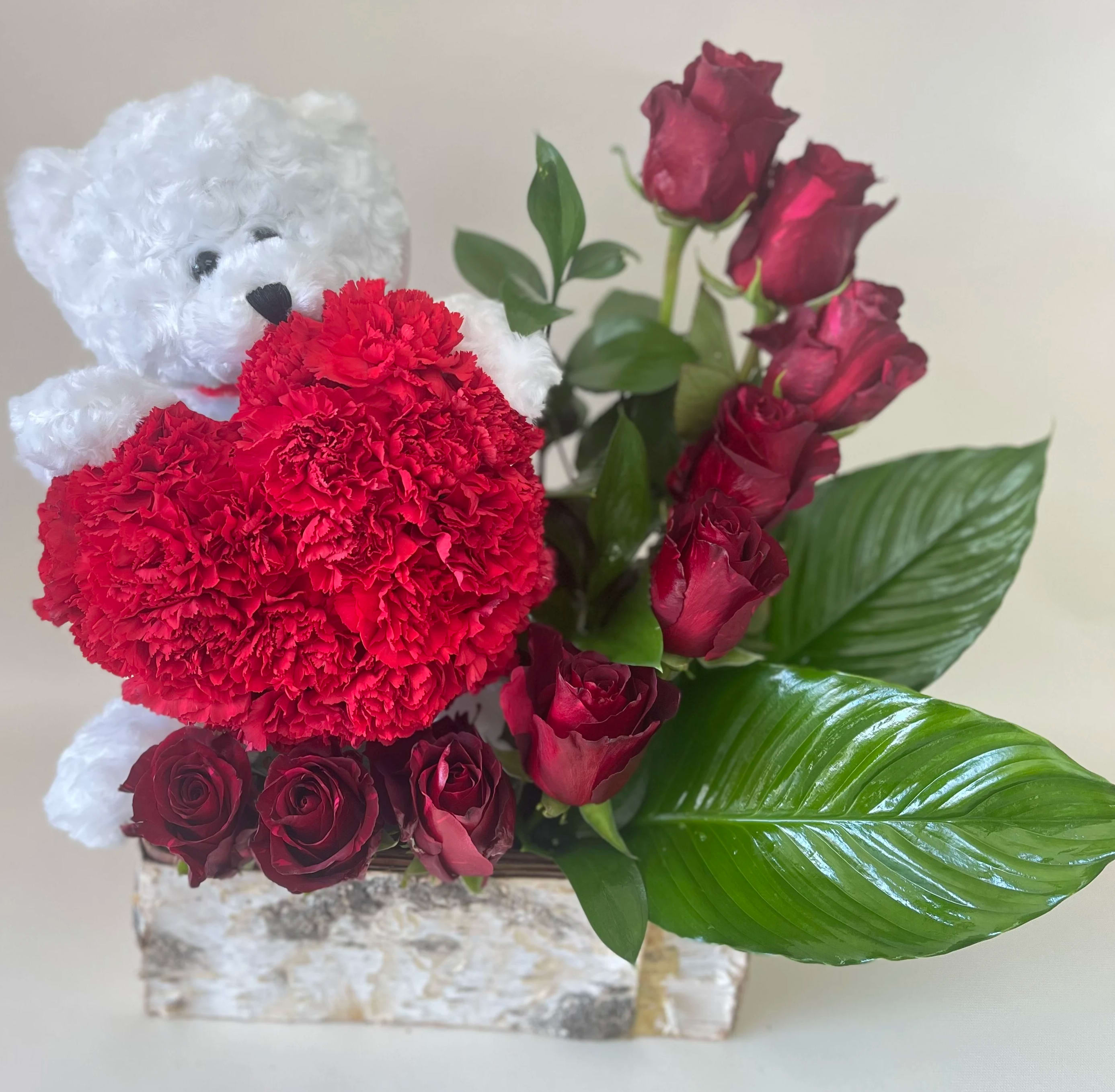 You have my heart You have my heart - Beautiful arrangement with a teddy bear holding a heart made by red carnations and a stair of roses. (any color can be substitute with the one of your choice)