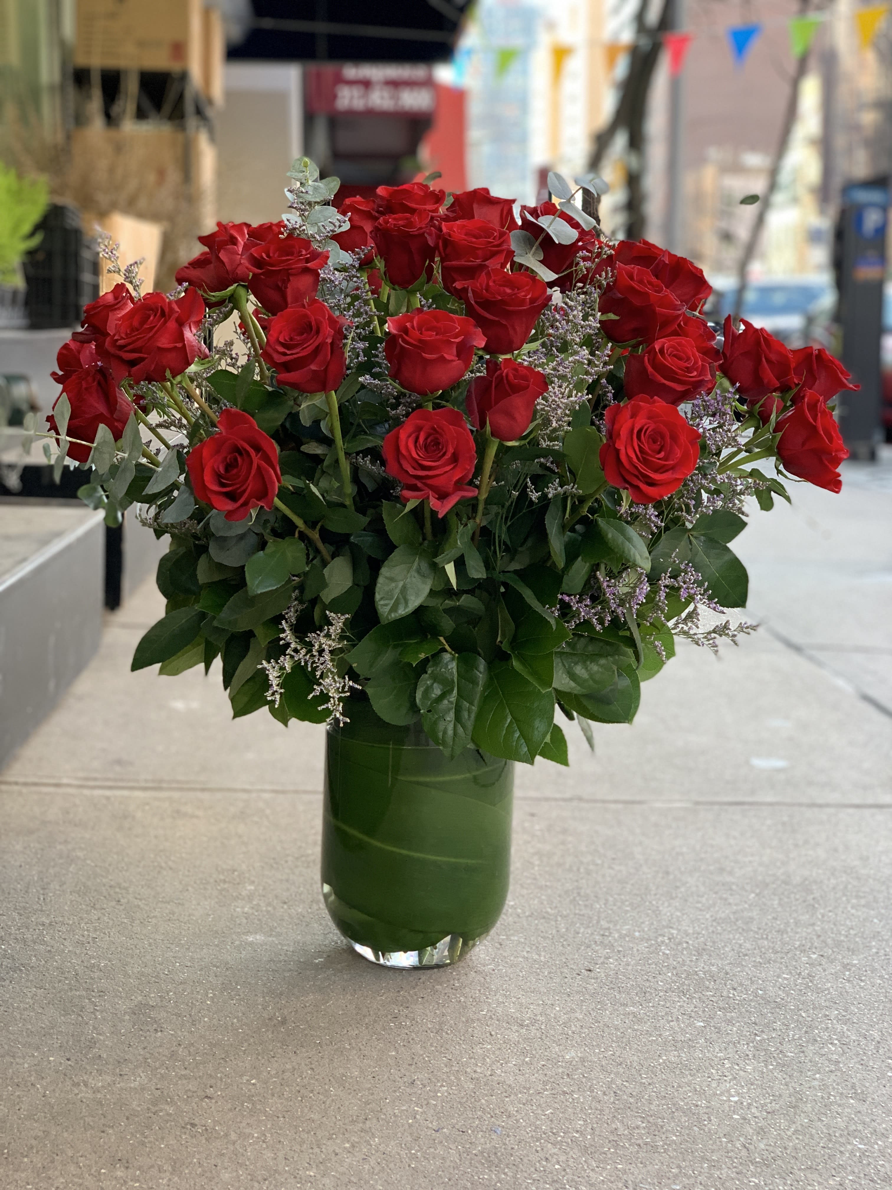 Three Dozen Red Roses - Three Dozen Classic long stem roses. Arranged in a tall vase with greenery, petite flowers  or branches to add extra volume that create a huge impact! Available in Red, White, Pink, Purple, Yellow, and Apricot