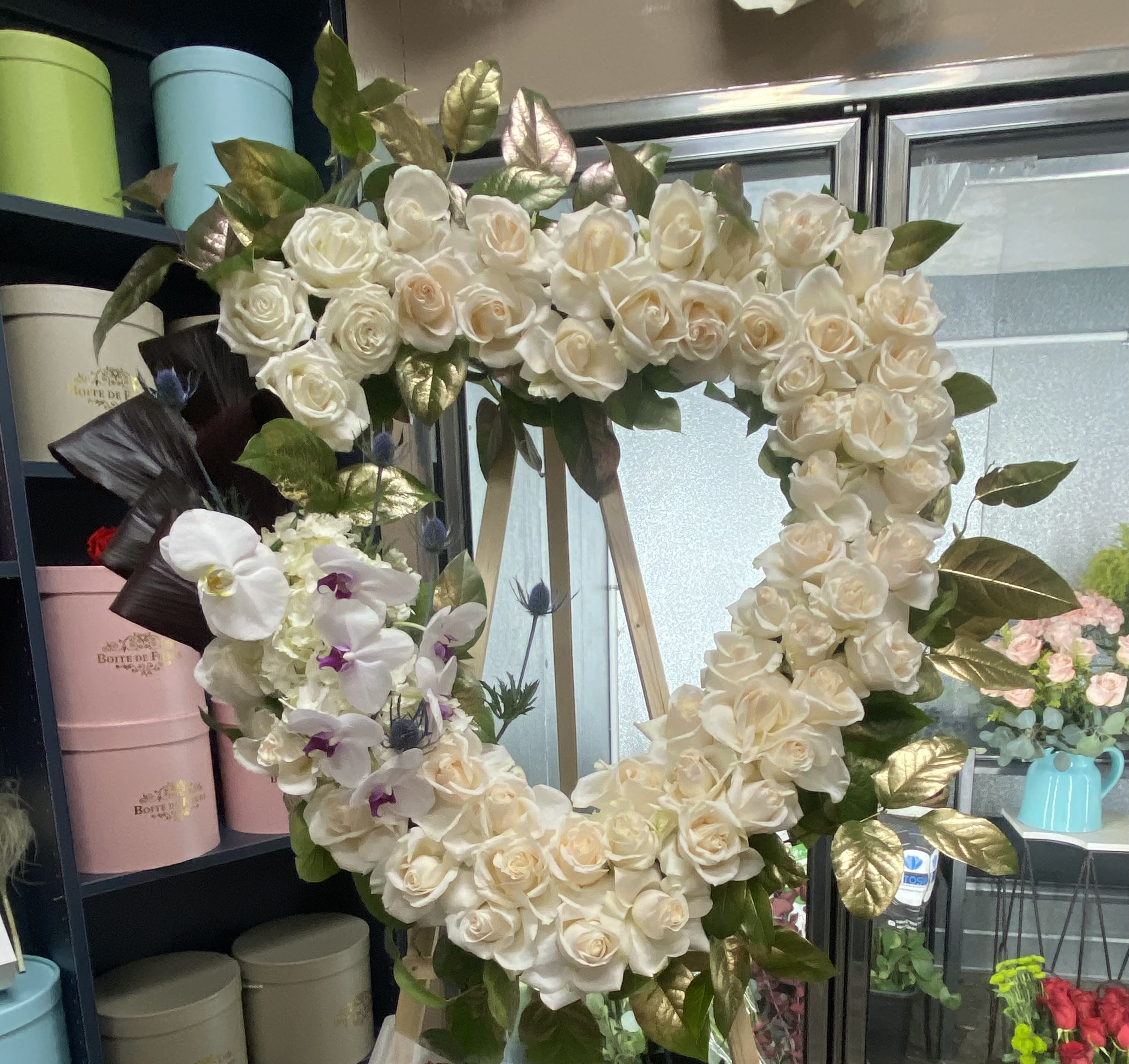 Sympathy White Heart Sympathy White Heart - Roses, orchids and foliage.