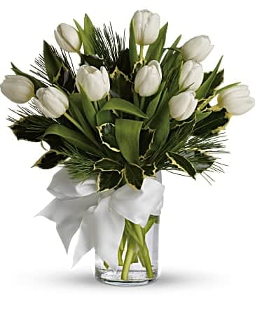 Tulips And Pine - For a wintertime bouquet that's as pure as the driven snow, send this unexpected gift of ten white tulips, accented with aromatic white pine, and adorned with a silver ribbon. A simple pleasure for a peaceful season. 10 white tulips and white pine are delivered in a clear glass vase that's accented with a silver ribbon. Orientation: All-Around