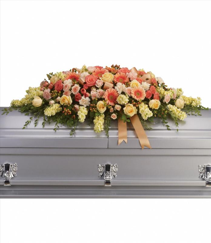 Warmest Remembrance Casket Spray Warmest Remembrance Casket Spray - This tastefully colorful casket spray is not only a tribute to a lost loved one, but a reminder of the many joyous times spent together. The beautiful bouquet includes peach roses, light pink spray roses, coral spray roses, light orange gerberas, light orange carnations, light yellow stock and peach hypericum, accented with satin ribbon and assorted greenery. Approximately 50" W x 17 1/2" H
