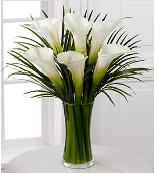 Endless Elegance Calla Lily Bouquet - Picked fresh from the farm to bring simple sophistication and clean, classic beauty to your special recipient's home or office, the Endless Elegance Calla Lily Bouquet is an impressive gift for any occasion. Hand gathered in select floral farms and showcasing the bright white that only blossoms from open cut calla lilies perfectly surrounded by lush, vibrant greens, this bouquet is picked fresh for you to help you expres your thanks, convey your deepest sympathies, or congratulate friends and family on an engagement or wedding. This bouquet includes: white calla lilies and vibrant green palm leaves. Presented with a clear glass vase. GOOD bouquet is approximately 17-inches in height. Your purchase includes a complimentary personalized gift message.