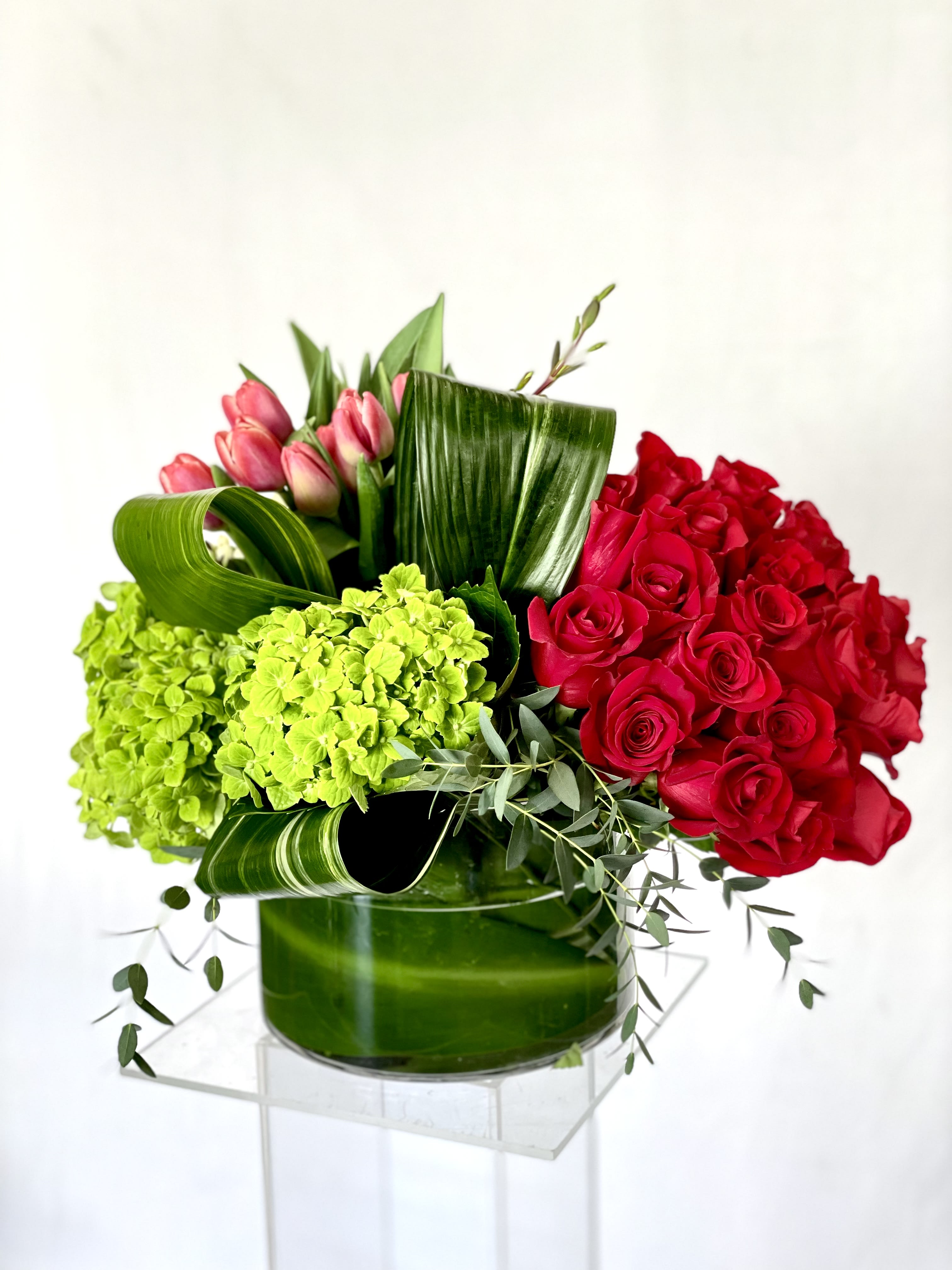 Stunning Love Stunning Love - Red roses, green hydrangeas, pink tulips, T-leaves, and baby eucalyptus.