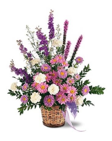 LAVENDER REMINDER BASKET - This lovely lavender arrangement, with its asters, chrysanthemums and larkspur, will remind us all that there's hope. One arrangement with lavender asters, chrysanthemums and larkspur, and white carnations and spray asters is delivered in a natural wicker basket.  Approximately 29&quot; W x 32&quot; H