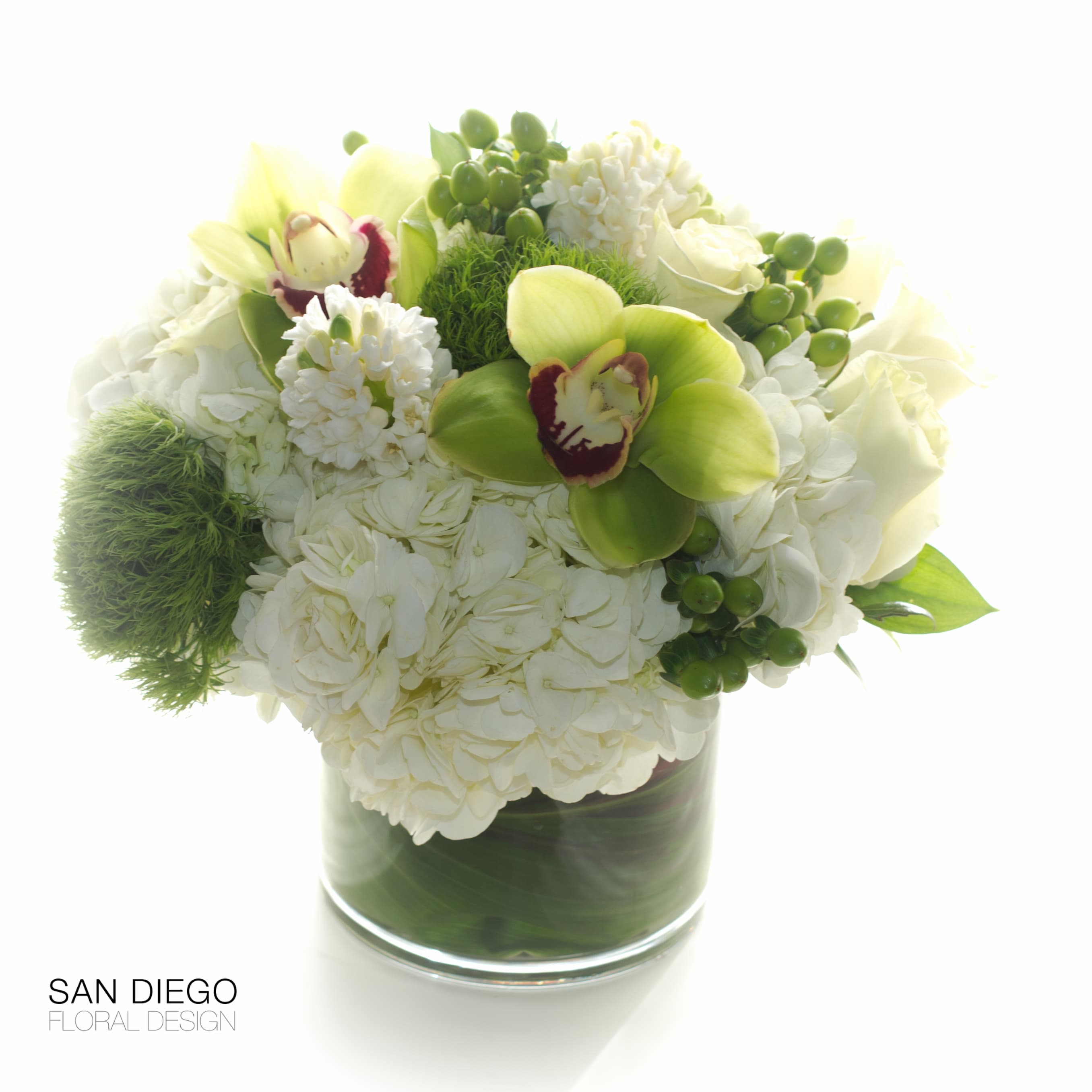 Flowers Of La Jolla  - Elegant simplicity. Hydrangeas, orchids, roses tulips in an  white and green arranged in a tea leaf wrapped glass cylinder vase. 