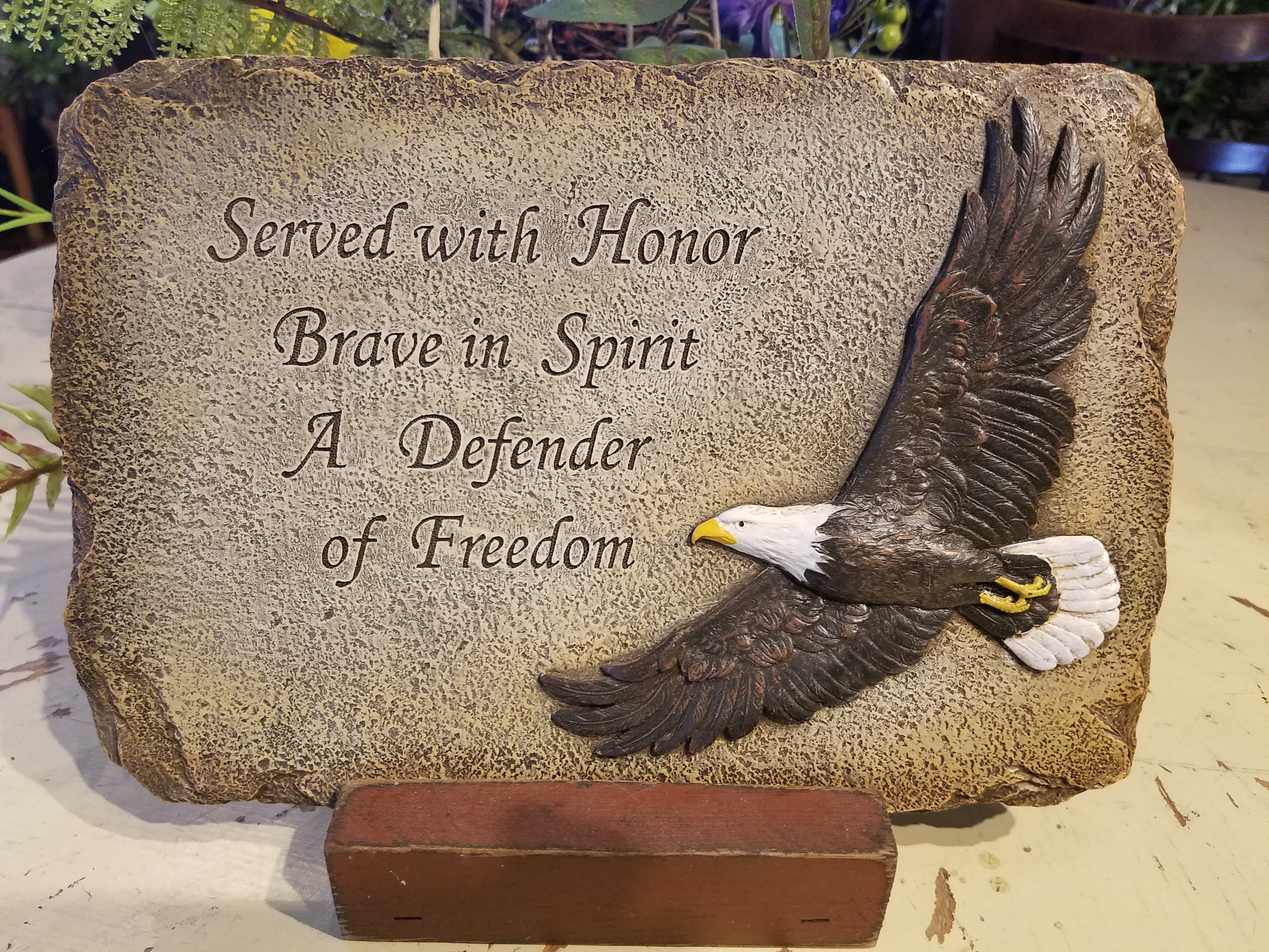 Eckert Florist's "Served with Honor" Memorial Stone *LOCAL DELIVERY ONLY Eckert Florist's "Served with Honor" Memorial Stone *LOCAL DELIVERY ONLY - Resin stone sentiment: "Served with Honor Brave in Spirit A Defender of Freedom." *May be added to a fresh arrangement or green plant. See Deluxe and/or Premium upgrades. *See Add-on Section for Display Easel Approx. 10" W X 7" H