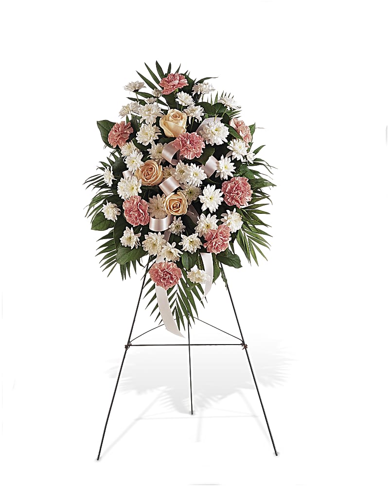 Loving Remembrance  - Standing Spray is a beautiful funeral gift to send in memorial of someone who has passed. Created with seasonal pastel flowers including carnations, Chrysanthemums and roses. The flowers are arranged in an oval shaped on a standing spray design to be placed in a funeral home during a service.