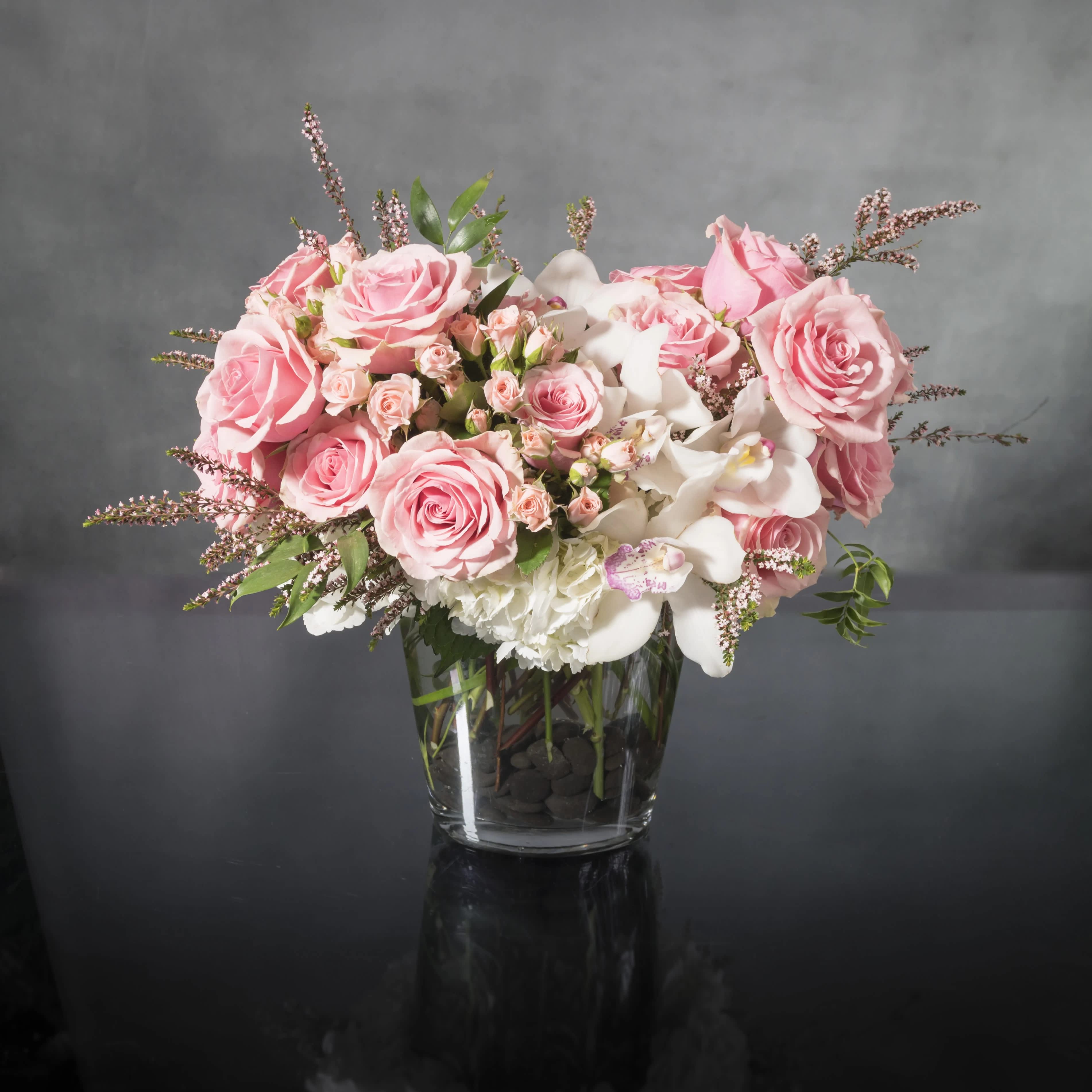 Girly Girl - &quot;Uniquely designed to create a memorable impression, this spectacular arrangement of beautiful, brilliant pink imported Orchids and Roses among white Hydrangeas is one of our best sellers! Its fullness and mix of soft luscious colors make this a favorite to express your sentiments for so many occasions.  Base 5&quot;&quot;, 15&quot;&quot; W x 12&quot;&quot; H.&quot;