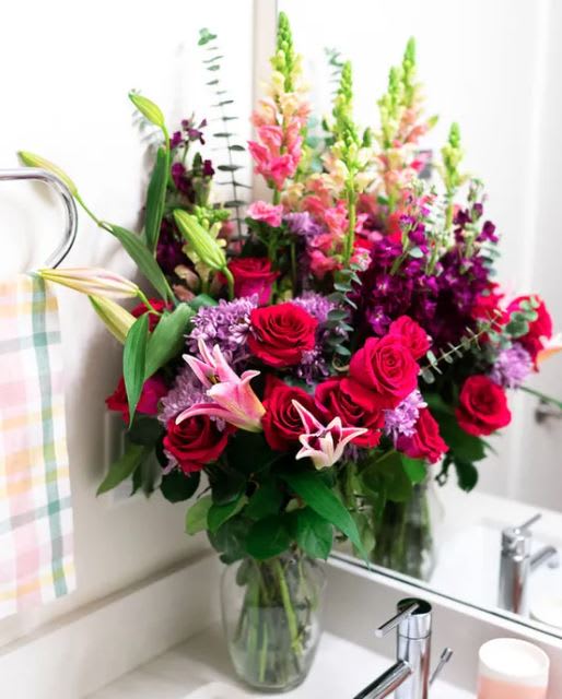 Valentine's day Elegance lily and rose bouquet - Valentine's day Elegance lily and rose bouquet Pretty in pink! Elegantly crafted, this vibrant fuchsia bouquet is the ultimate way to celebrate the best mom in the world - yours! It's artistically arranged with a truly decadent bouquet of hot pink roses, fragrant stargazer lilies and pink snapdragons - a Mother's Day gift she'll never forget!  • Hot Pink Roses • Pink Stargazer Lilies • Burgundy Stock • Lavender Cushion Spray Chrysanthemums • Pink Snapdragons • Spiral Eucalyptus • Lemon Leaf • Glass Vase 