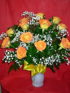 HIGH AND MAGIC ROSES  NEW-R07 - DOZEN LONG STEM PREMIUM HIGH AND MAGIC ROSES are some of the largest bloom head and long lasting roses in the yellow rose family.  They are arranged in a quality glass vase with white babies breath and with a vibrant yellow bow. Phone us at 1-800-331-5358 for other colors and all your specific rose needs.  