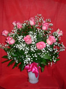 Dozen Carrousell Roses NEW-R06 - ONE DOZEN PREMIUM, LONG STEM, CAROUSEL ROSES ARRANGED IN A QUALITY GLASS VASE WITH WHITE BABIES BREATH.  THESE ARE A VERY LONG LASTING VARIETY OF PINK ROSES, WITH A VIBRANT HOT PINK EDGE TO THE PETALS.. FOR OTHER COLORS PLEASE PHONE US AT 1-800-331-5358 FOR ALL OF YOUR SPECIFIC ROSE NEEDS  APPROX.. 26H X 22W