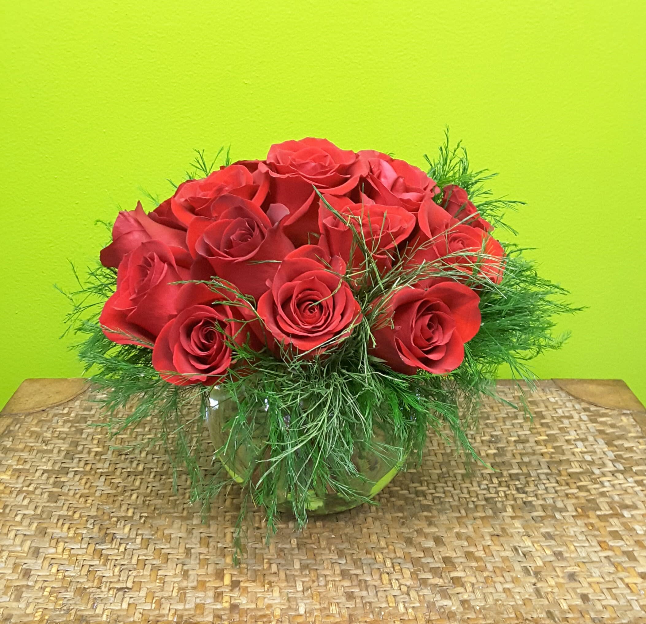 MODERN ROSES NEW-A38 MODERN ROSES NEW-A38 - Our MODERN ROSE arrangement is a dozen roses stylishly arranged,low and compact in a round bubble ball container with greens for that modern look .. Great for a coffee table, side table or any location were a dramatic , modern floral accent is needed.. For larger arrangements , similar in style , please phone us at 1-800-331-5358 for your special needs.