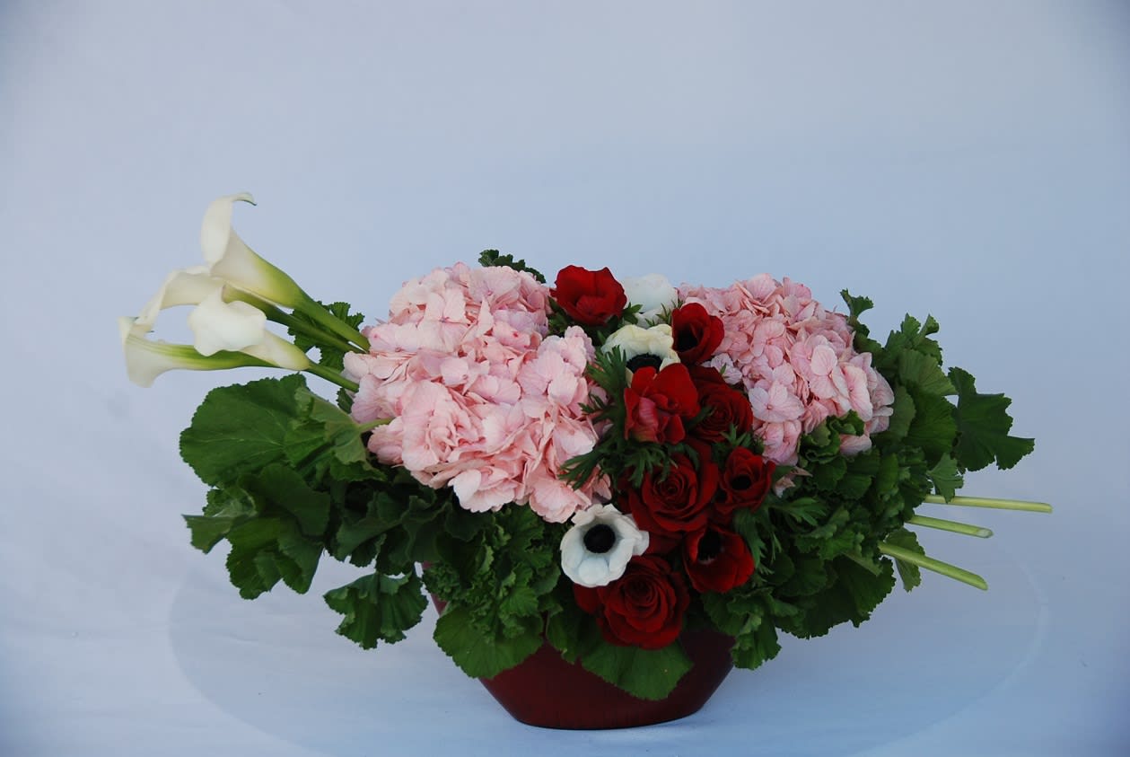 XOXO - A heart shaped arrangement in pinks and red with hydrangeas, red roses, and French anemones and calla lilies perfect for Anniversary, Valentin's Day or Birthday