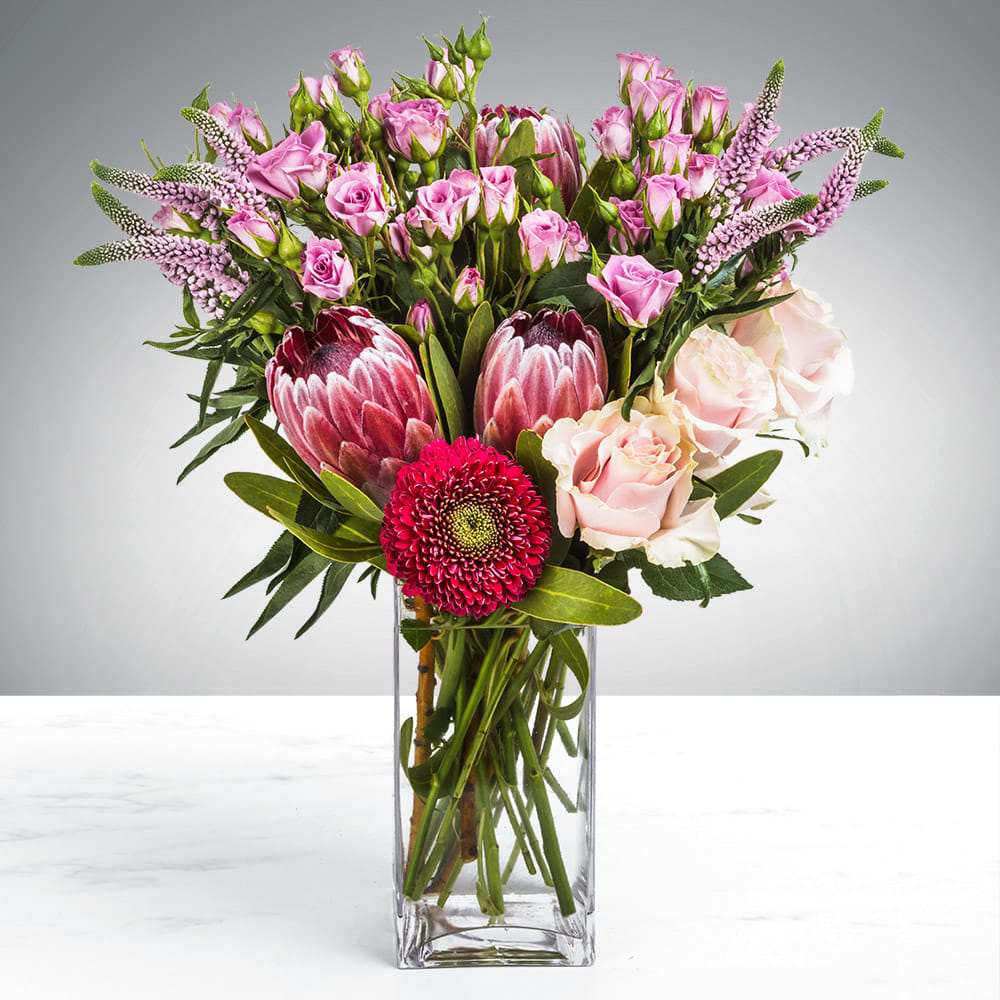 Pink Skies By BloomNation™ Pink Skies By BloomNation™ - Do you want your flowers to sing you a lullaby? That’s impossible, flowers do not have vocal chords. Until now. Introducing Pink Skies. So graceful, so beautiful, having this arrangement is like holding a song in your hands. Note: this arrangement does not sing or have vocal chords.