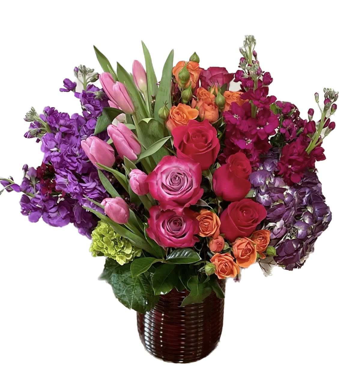 Crown Jewel - A beautiful arrangement of bright, eye catching jewel tones.  Arranged in a tasteful red, ribbed, glass vase.  Send some gorgeous color to that special someone this Valentines Day!