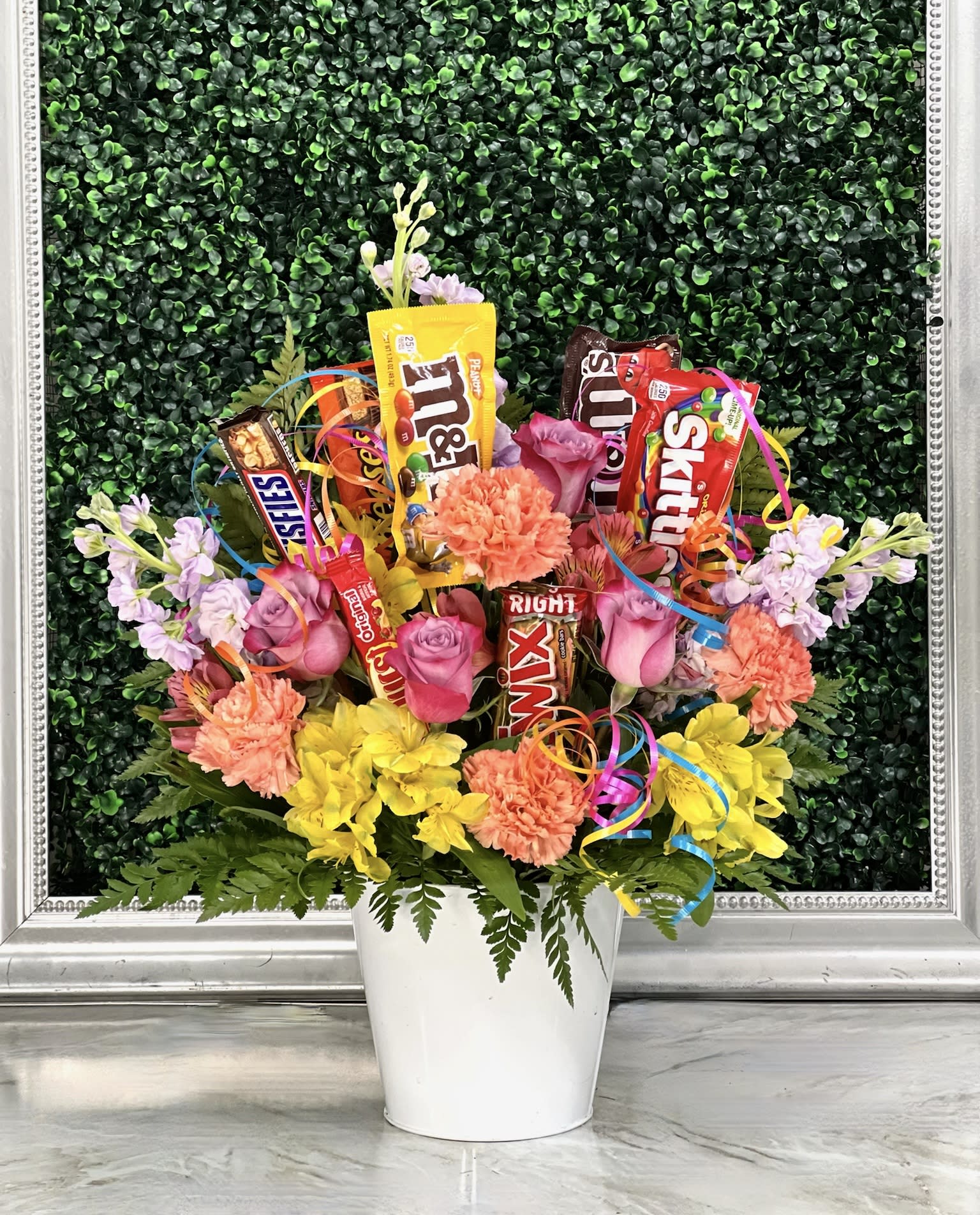 Candy Warhol - Perfect for any celebration, this spring mix arrangement is filled with an assortment of candies and fun curling ribbon that is sure to make anyone's day!