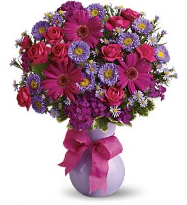 Joyful Jubilee Joyful Jubilee - Sending a jubilation of flowers is a joyful way to brighten any celebration. This particular arrangement is eye-catching, colorful and captivating. Hot pink spray roses and gerberas, dark pink Sweet William, lavender matsumoto and purple monte cassino asters are joined by greens in an exclusive lavender keepsake vase. Tied with a ribbon, it's ready to shine. Approximately 14" W x 17" H Orientation: All-Around