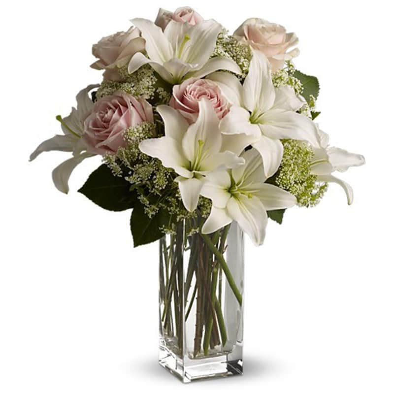 Heavenly and Harmony - Heavenly hues and pretty petals are in perfect harmony in this gorgeous arrangement. Lovely for a birthday, anniversary or just because, it's simply stunning!  Light pink roses, white asiatic lilies, Queen Anne's lace and salal are beautifully arranged in a glass vase. Heaven sent? Well, someone will think you're an angel for sending it!  Approximately 10&quot; W x 18&quot; H  Product ID: T55-1A