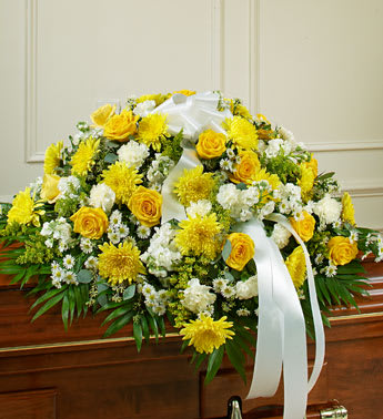 Cherished Memories Half Casket Cover - Yellow - Product ID: 91220   This beautiful casket cover reflects your deepest sympathies and love for a life well lived. Features gorgeous long stem yellow roses, white cremones, carnations and more, accented by crisp greenery. Traditionally sent by the immediate family directly to the funeral home Due to the urgency of the occasion, our florists use only the freshest flowers available, so colors and varieties may vary Arrangement measures approximately 16âH x 28âW x 38âL