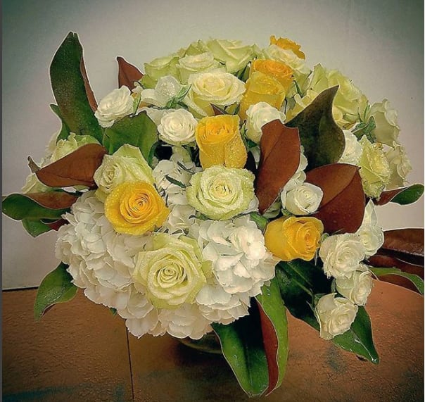 Adorn your Table Adorn your Table - yellow white and cream roses with a pillow of white hydrangea