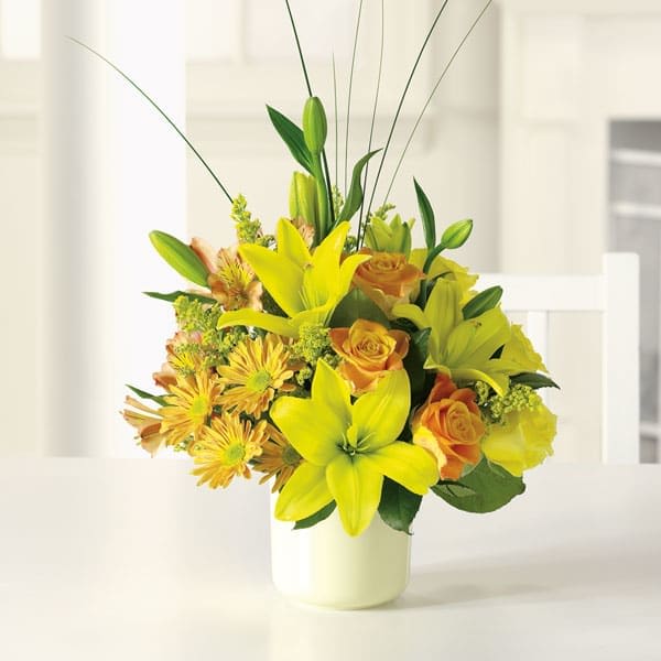Sunshine Splendor Sunshine Splendor - Bright-yellow lilies and fire-orange roses awaken the senses with sunny greetings for any occasion. Brighten someone's day today!