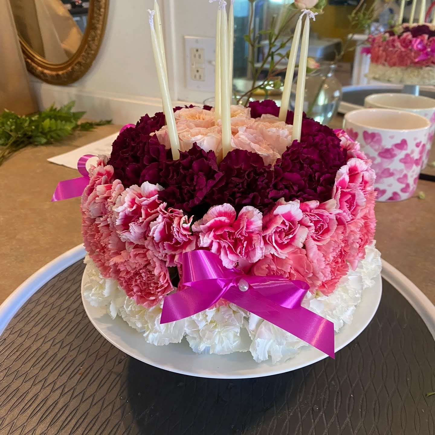 Birthday flower cake - Celebrate your next birthday with this customizable flower birthday cake. Can customize color be bold or stay soft. Includes carnations, pom poms, roses, and candles. 