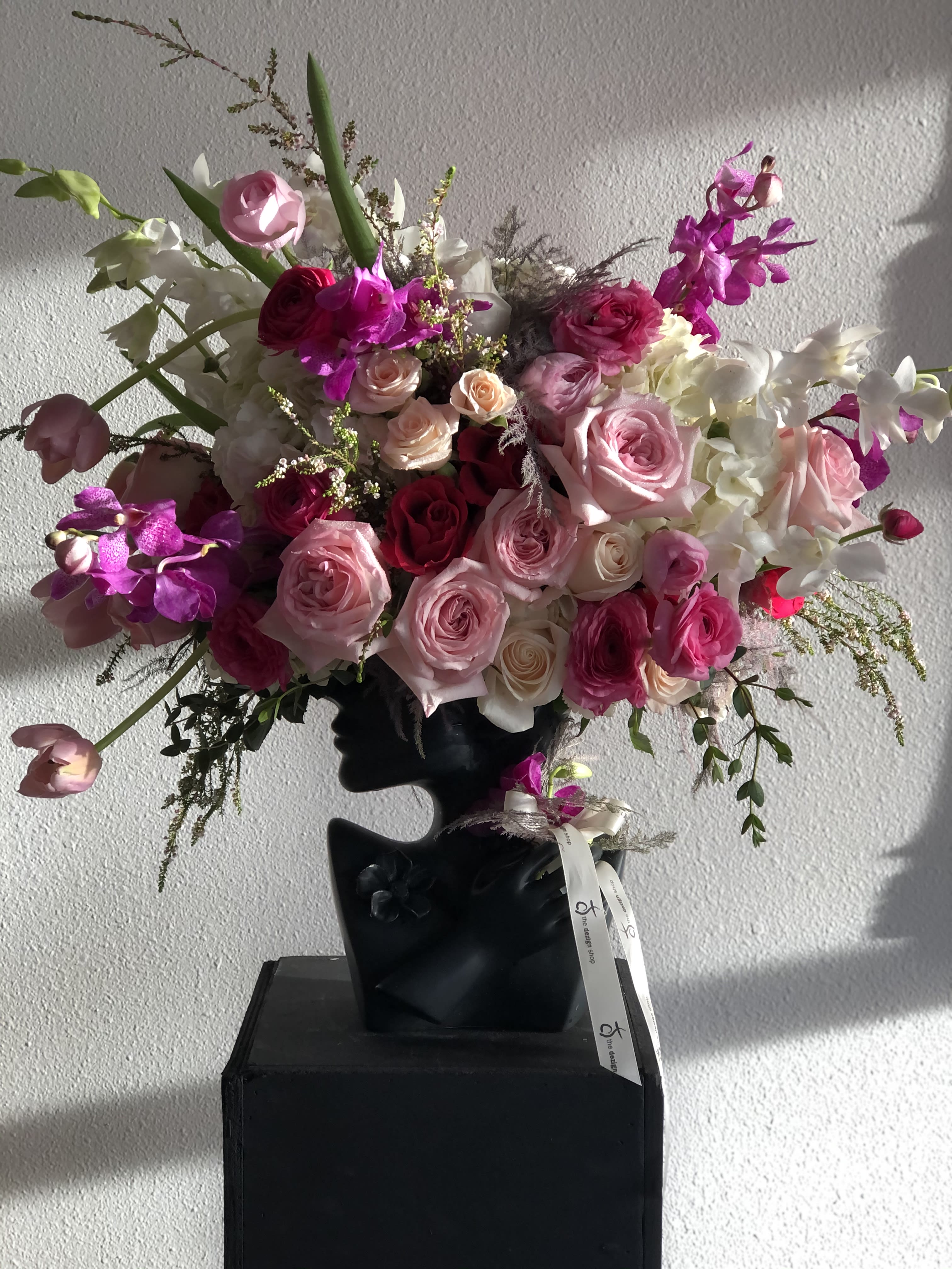 Blooming Mind Blooming Mind - Lady shaped vase arranged with all shades of pink flower head. Unique and unexpected floral will surprise anyone and make a huge impression.
