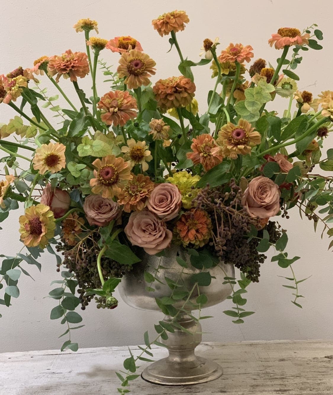 Wildflower Girl - A growing garden of wildflowers sprouting tall from urn.