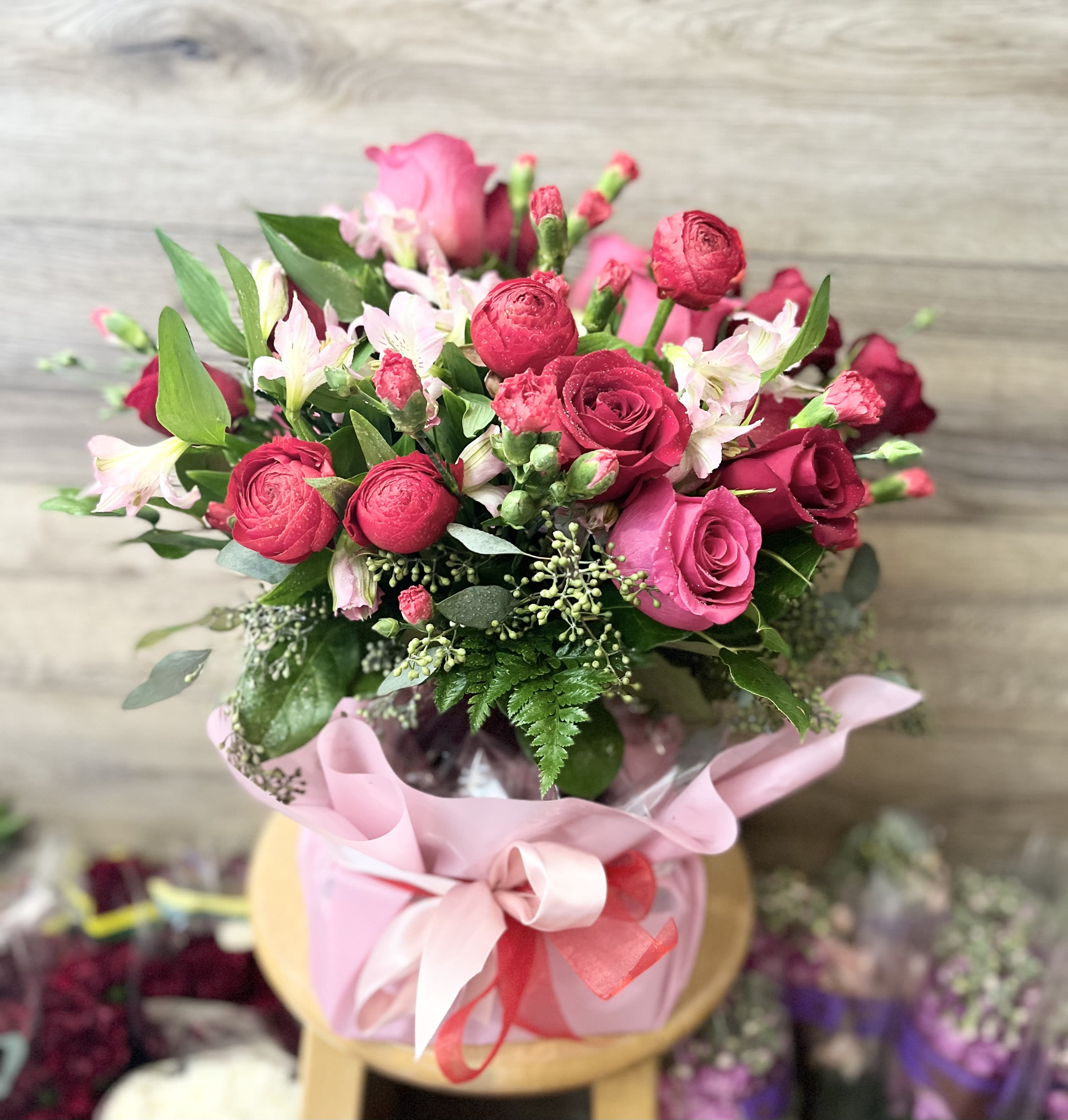 Jane - Mix of red and pink flowers in vase 