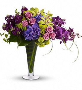 Your Majesty - This stunning tropical bouquet really is fit for a queen. It's an elegant mix of vibrant flowers set in a tall vase lined with tropical leaves. It makes a beautiful addition to a modern home or outstanding office décor.  A lovely mix of blue hydrangea, green cymbidium orchids, mokara orchids, lavender roses and lots more are delivered in a footed and flared glass vase. Make magic happen for her majesty!  Approximately 23&quot; W x 21&quot; H  Orientation: One-Sided
